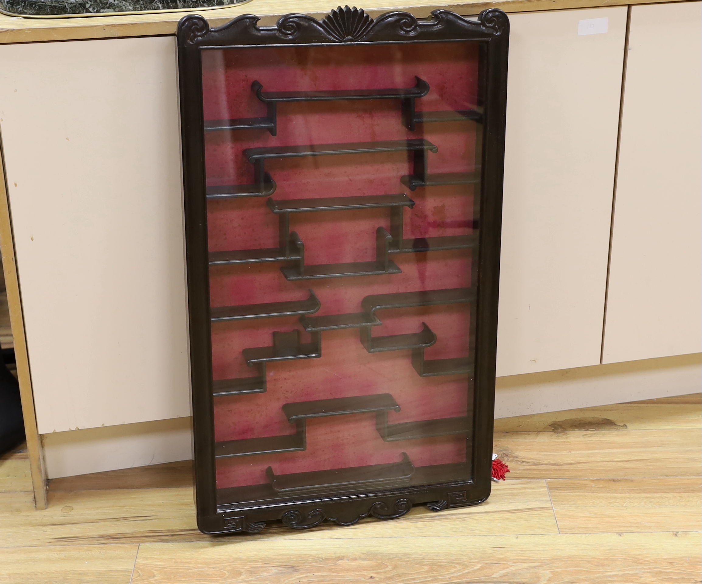 A Chinese hardwood snuff bottle cabinet with glazed front and key, 85cm high